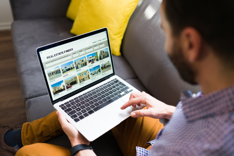 Man checking ads of houses for sale